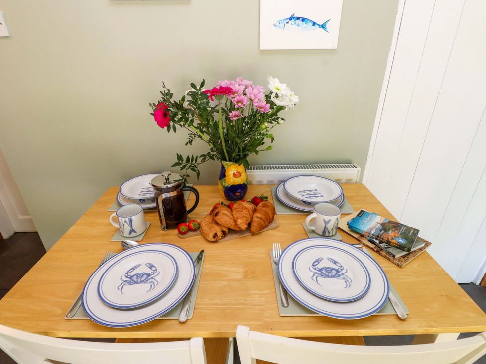 A dining room with a table set for breakfast at Woodman's Lodge Llanallgo near Moelfre