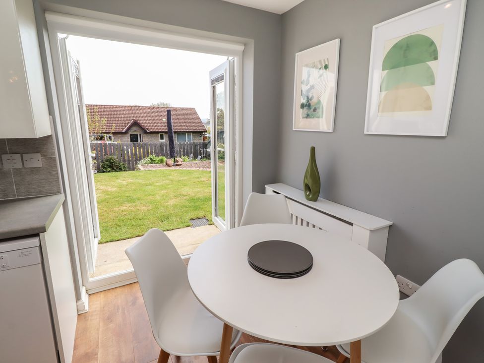 A dining area with a table and chairs at 26 Field Court