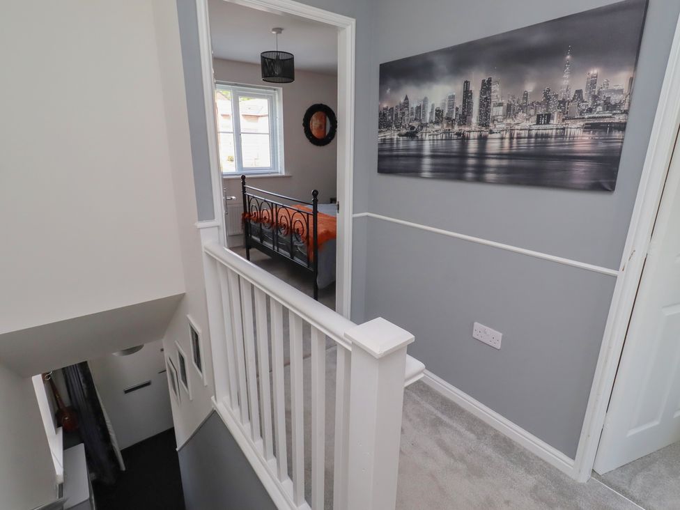 A hallway showing staircase and a bedroom at 26 Field Court
