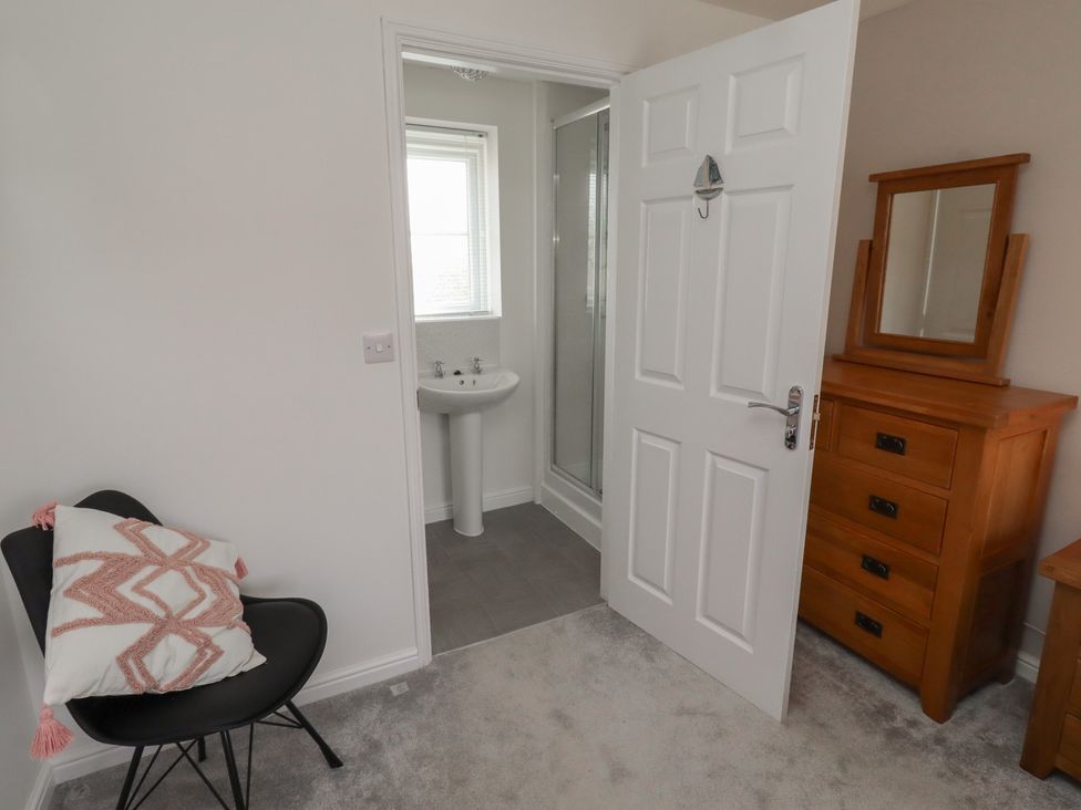 A bathroom with a washbasin and shower at 26 Field Court
