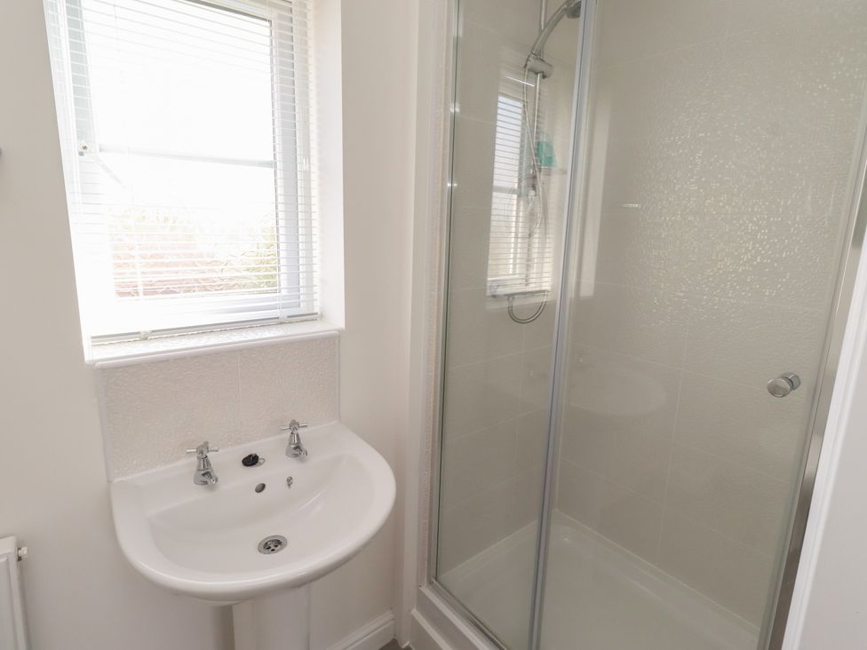 A bathroom with a sink and shower at 26 Field Court