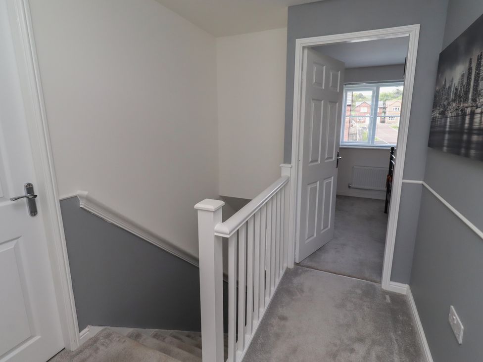 A staircase and hallway leading to a room at 26 Field Court 