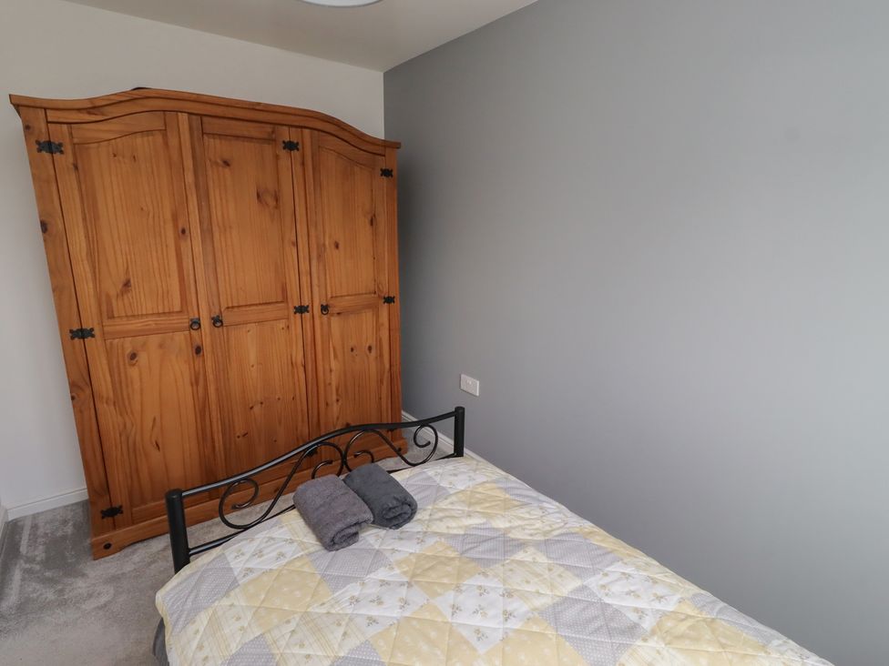 A bedroom with a bed and wardrobe at 26 Field Court 