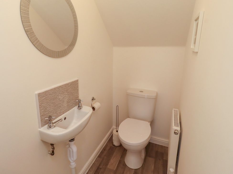 A bathroom with a sink and toilet at 26 Field Court