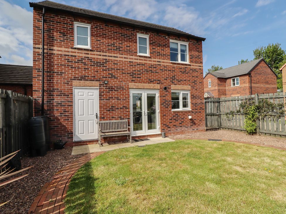 A house with a garden and bench at 26 Field Court
