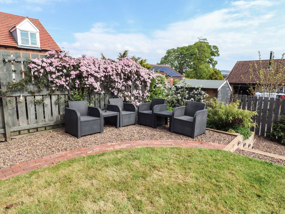 A garden area with chairs and flowers at 26 Field Court