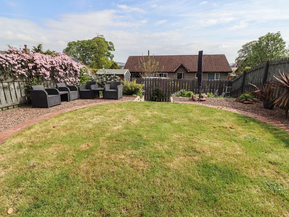 A garden with seating area and plants at 26 Field Court