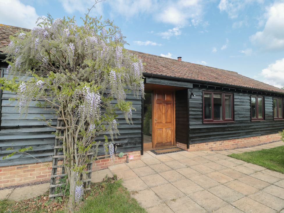 A house exterior with a wooden door and wisteria at Annex at Barnfield House Devizes