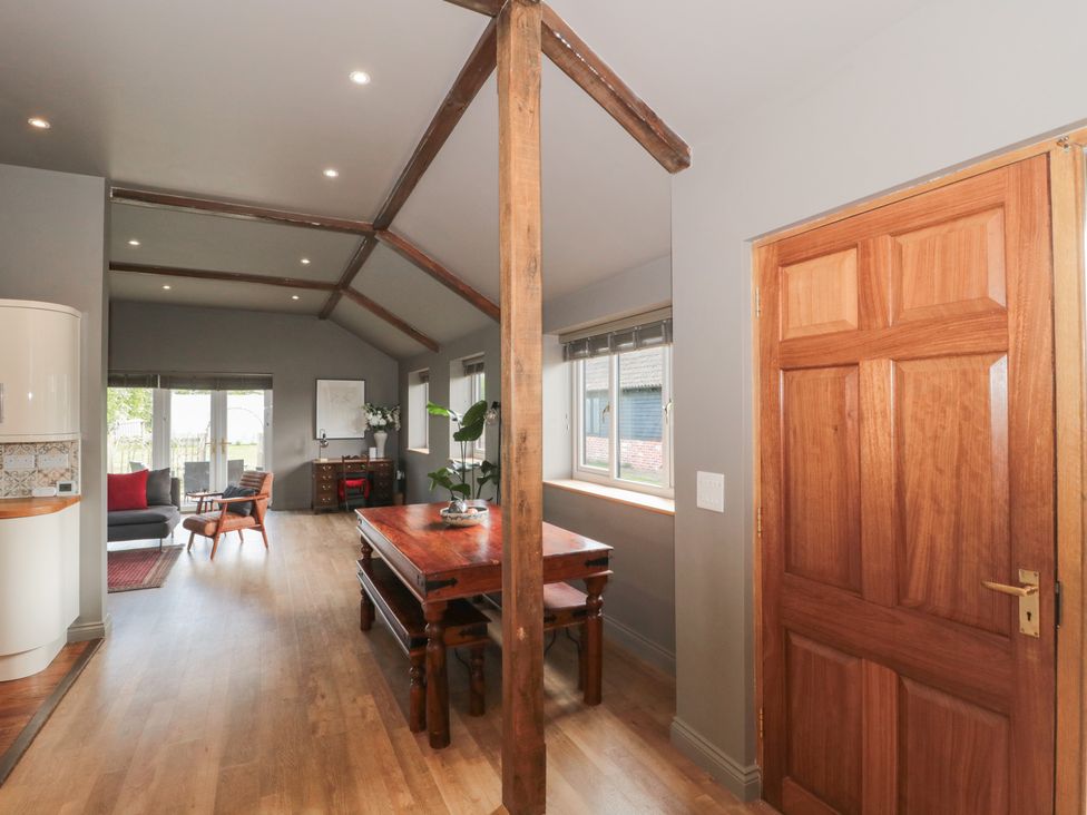 A living room with a wooden table and chairs at Annex at Barnfield House in Devizes