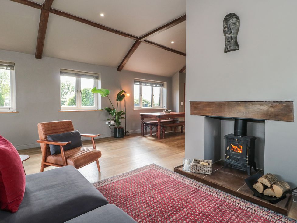 A living room with a sofa and a fireplace at Annex at Barnfield House in Devizes