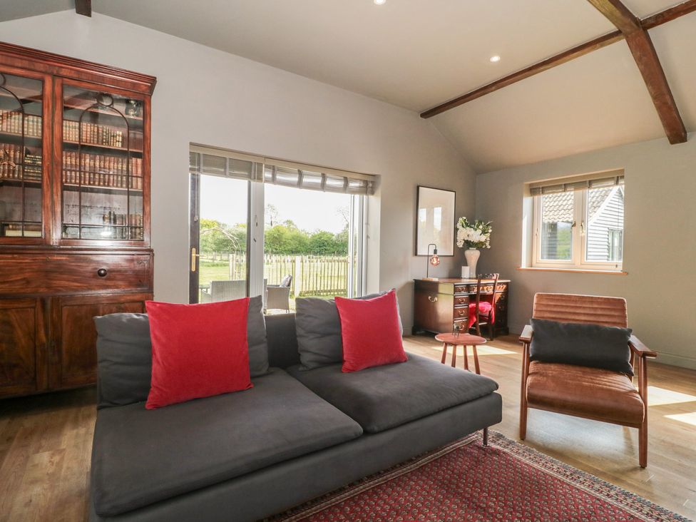 A living room with a sofa and bookshelf at Annex at Barnfield House, Devizes