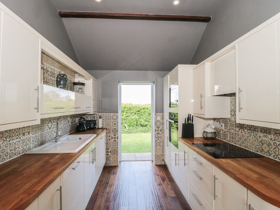 A kitchen with a sink and cabinets at Annex at Barnfield House in Devizes