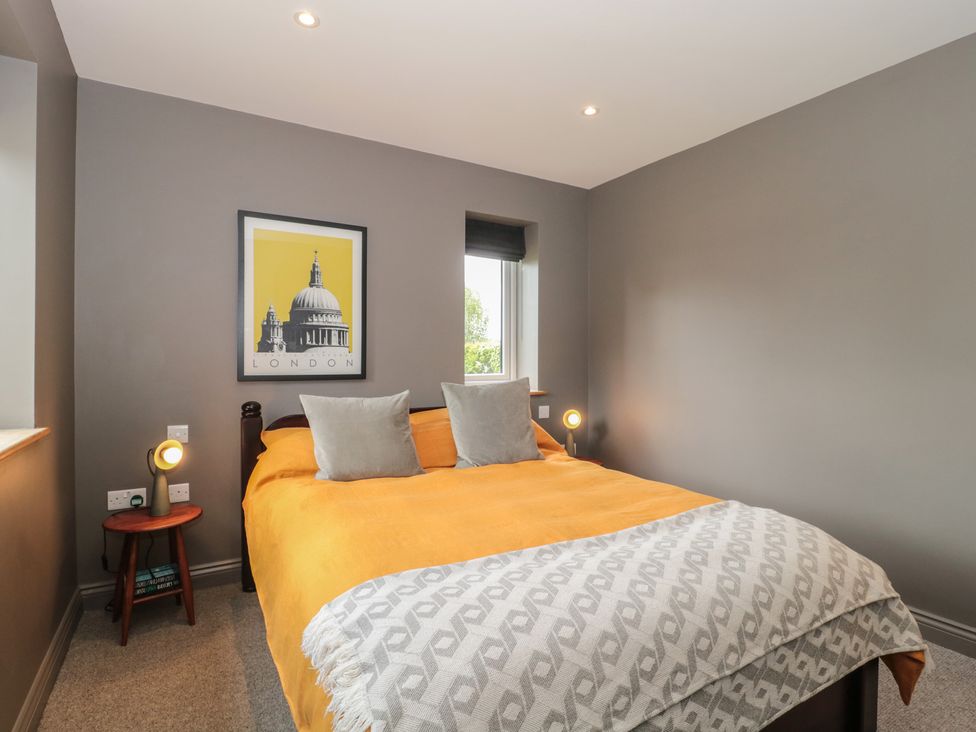 A bedroom with a bed and a framed picture at Annex at Barnfield House Devizes