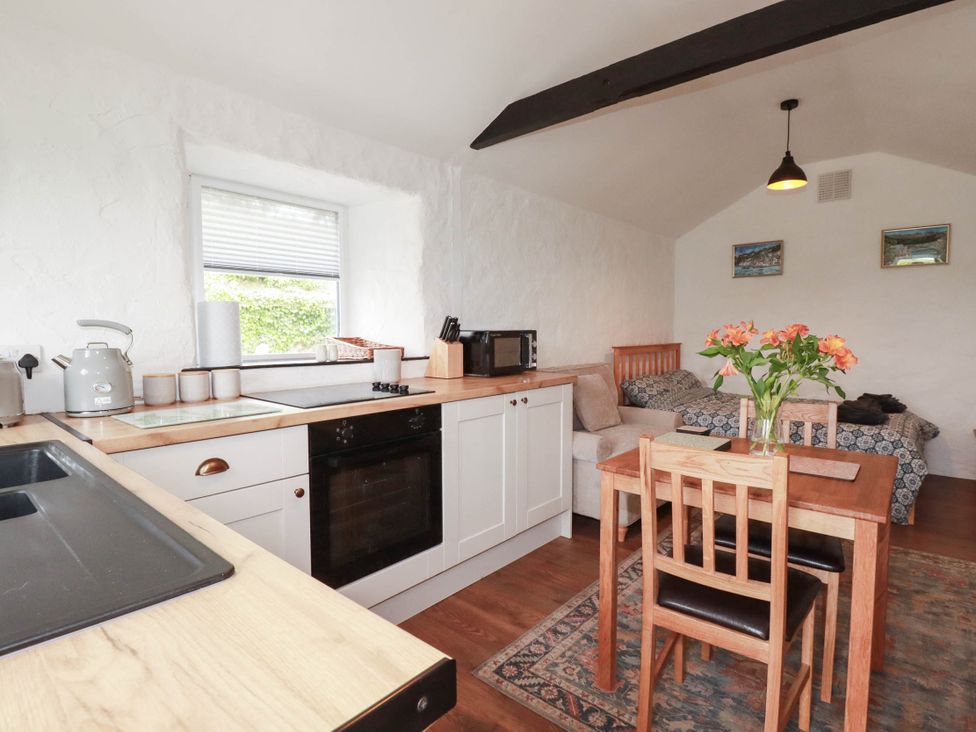 A kitchen with furniture and appliances at Primrose Cottage in Redruth