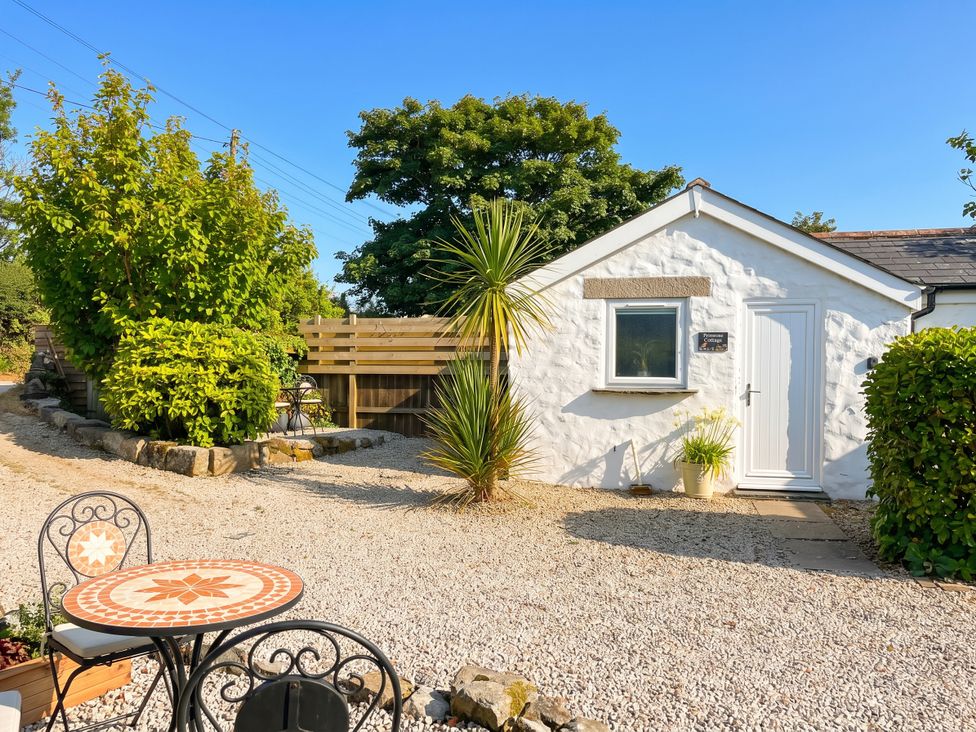 A cottage entrance with table and chairs at Primrose Cottage Redruth