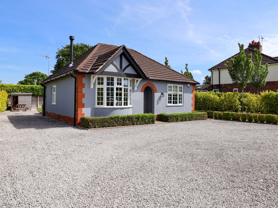 A house with a gravel driveway and greenery at 18 Crewe Road in Crewe