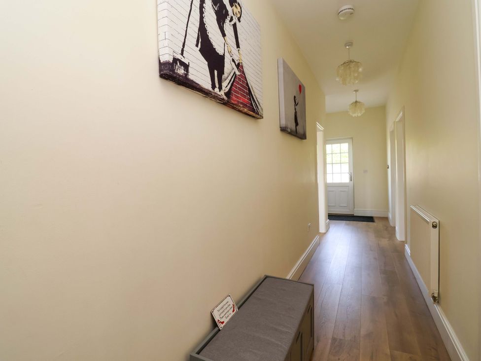 A hallway with wall art and a bench at 18 Crewe Road Crewe