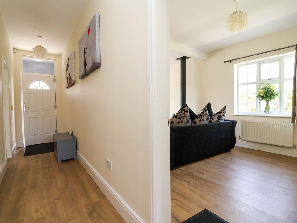 A hallway with a front door and sofa visible at 18 Crewe Road in Crewe
