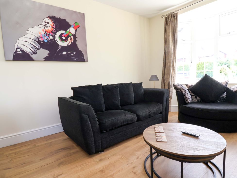 A living room with a sofa and coffee table at 18 Crewe Road, Crewe