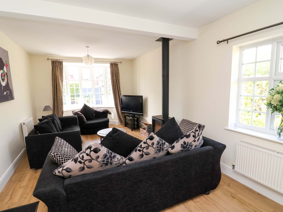 A living room with sofas and a television at 18 Crewe Road in Crewe