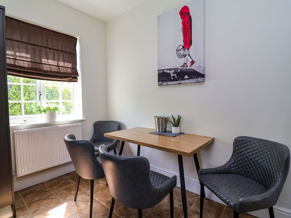 A dining room with a table and chairs at 18 Crewe Road in Crewe