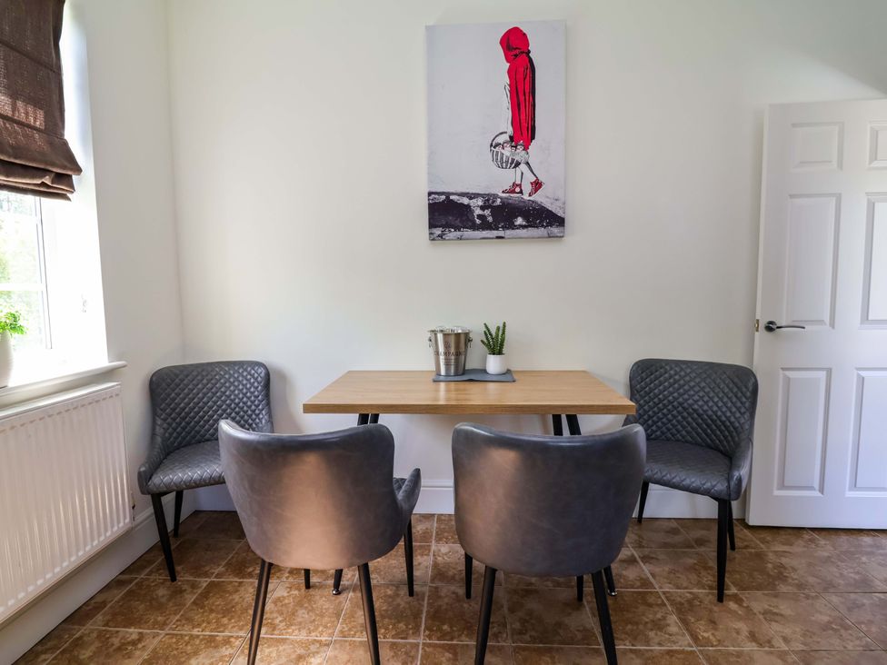 A dining room with a table and chairs at 18 Crewe Road in Crewe