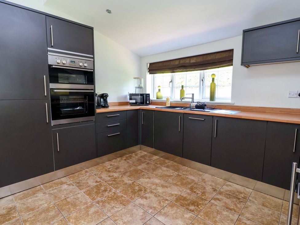 A kitchen with cabinets and appliances at 18 Crewe Road in Crewe