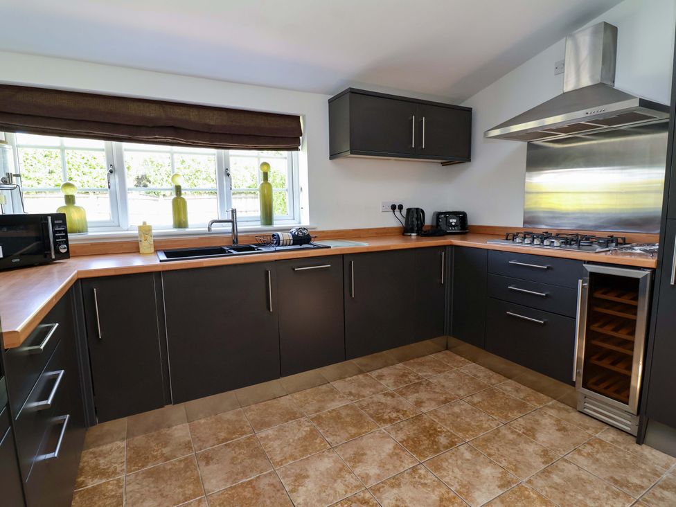 A kitchen with sink, cabinets, and appliances at 18 Crewe Road in Crewe