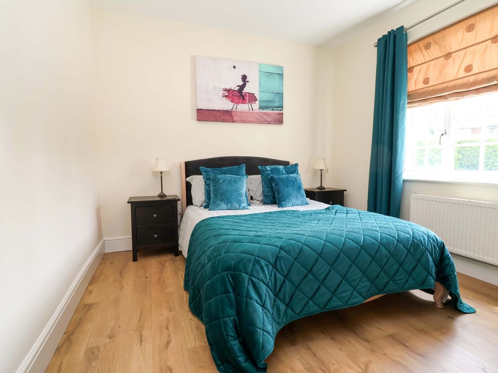 A bedroom with a bed and nightstand at 18 Crewe Road, Crewe
