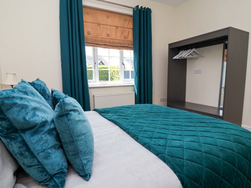 A bedroom with a bed and wardrobe at 18 Crewe Road in Crewe