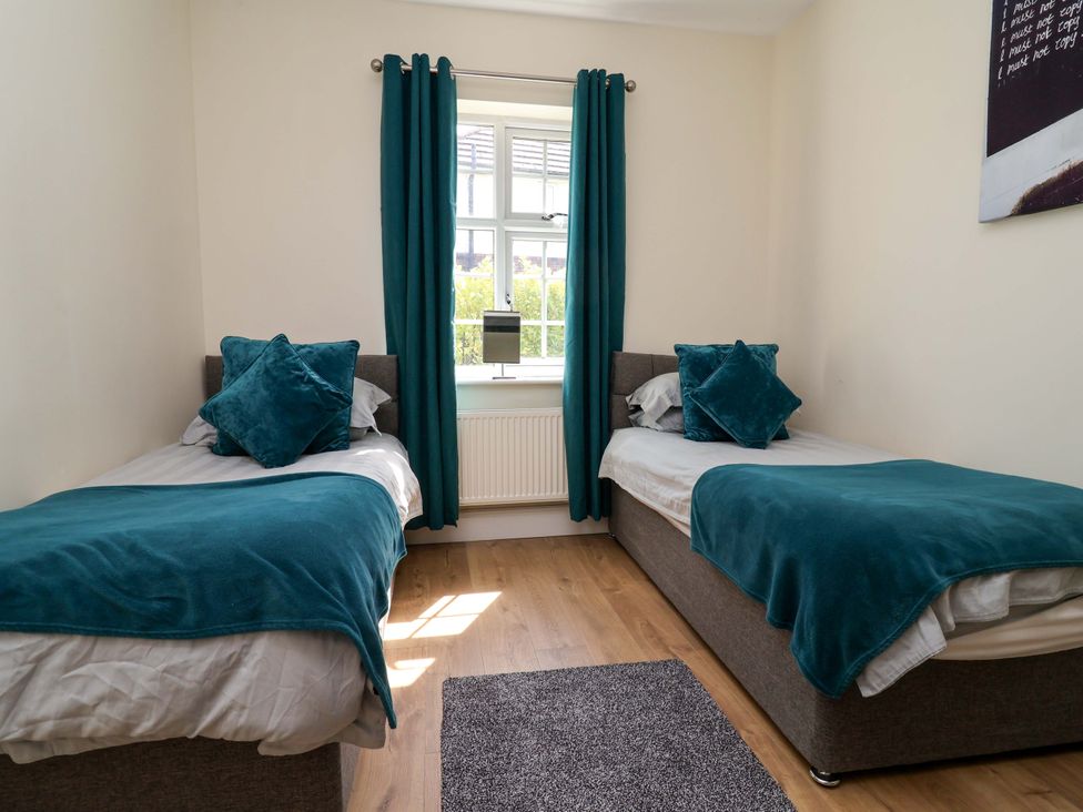 A bedroom with two beds and a window at 18 Crewe Road in Crewe