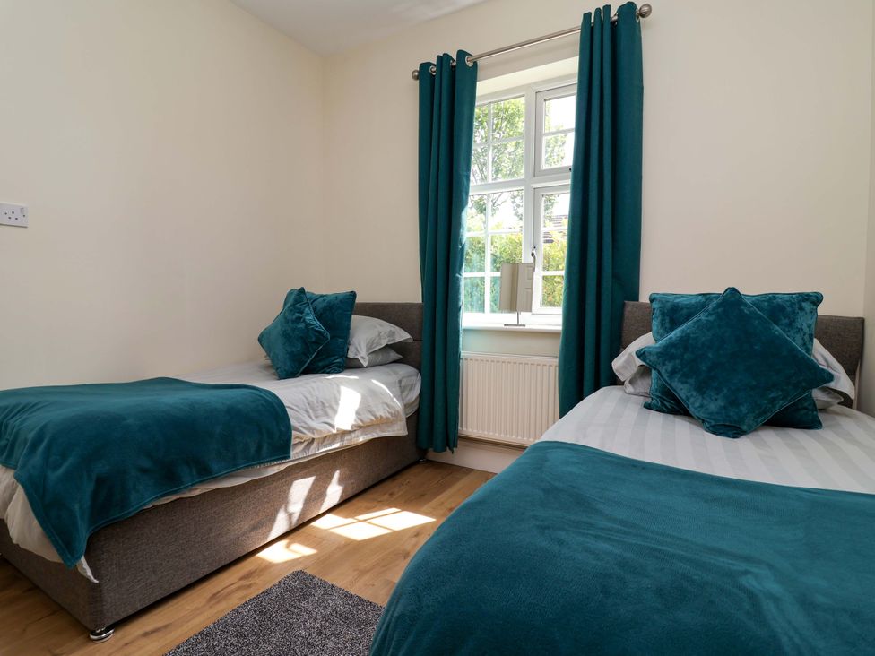 A bedroom with two beds and a window at 18 Crewe Road, Crewe