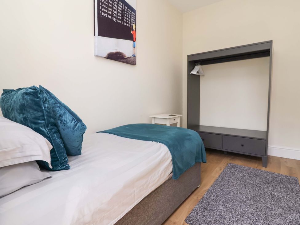 A bedroom with a bed and wardrobe at 18 Crewe Road in Crewe