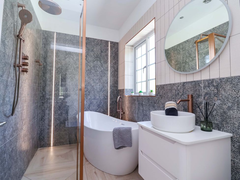 A bathroom with a bathtub and sink at 18 Crewe Road in Crewe