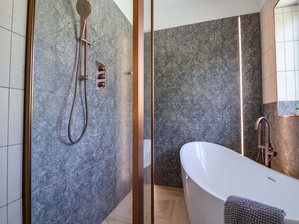 A bathroom with a shower and bathtub at 18 Crewe Road, Crewe