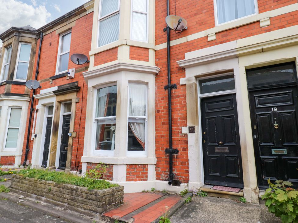 A front exterior view of a building with brick walls and doors at 17 Fairfield Road