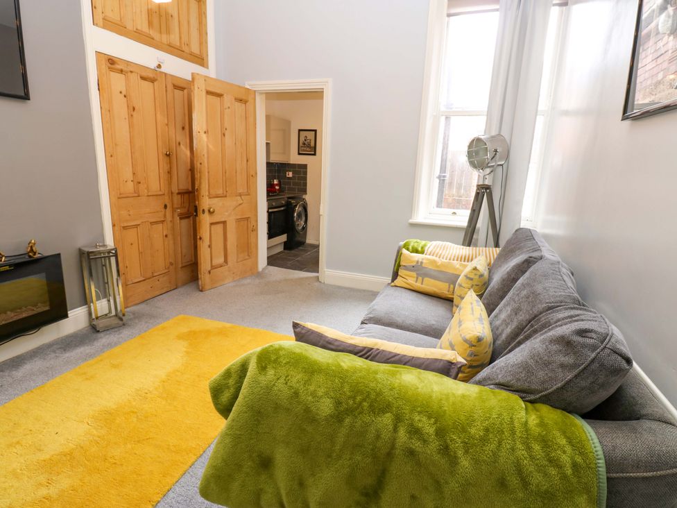 A living room with a sofa and a door at 17 Fairfield Road