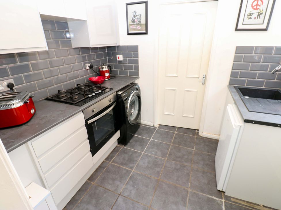 A kitchen with appliances and a washing machine at 17 Fairfield Road