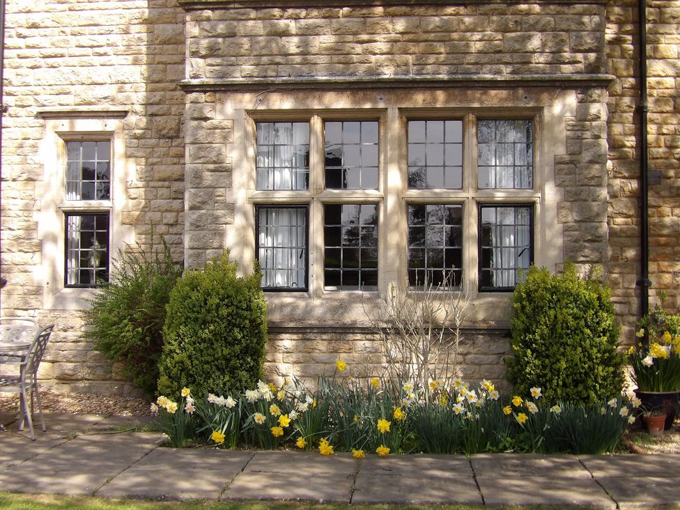 An outdoor area with a window and flowers at Greenwood Manor in Peterborough