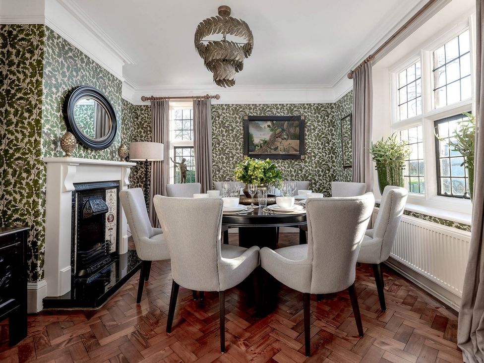 A dining room with a table set for dinner at Greenwood Manor in Peterborough