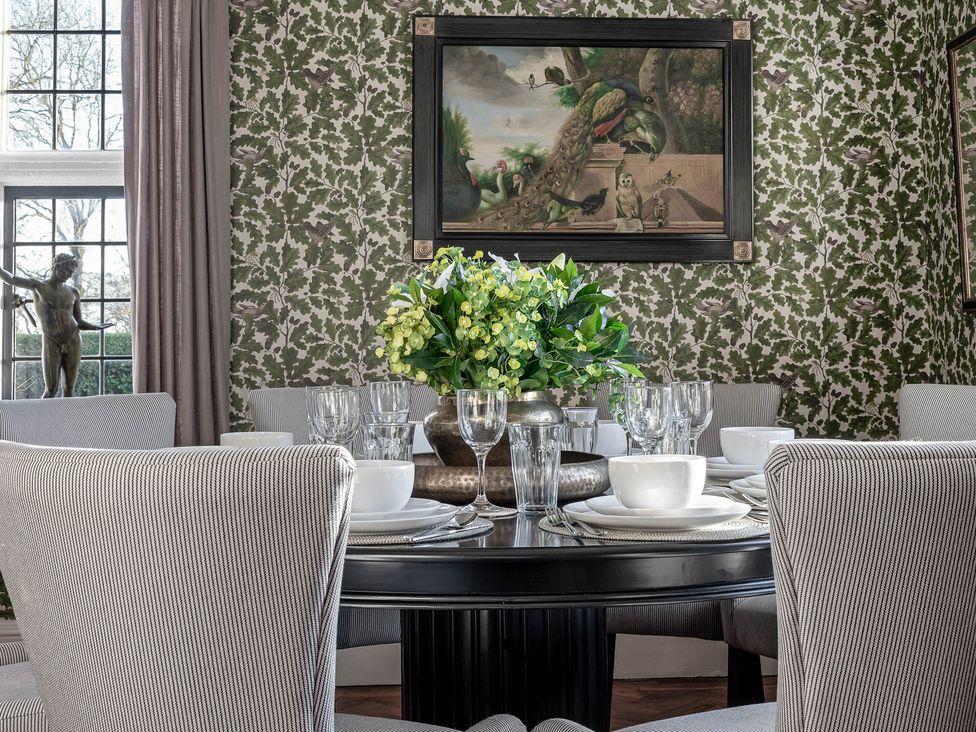 A dining room with a table set for dinner at Greenwood Manor in Peterborough