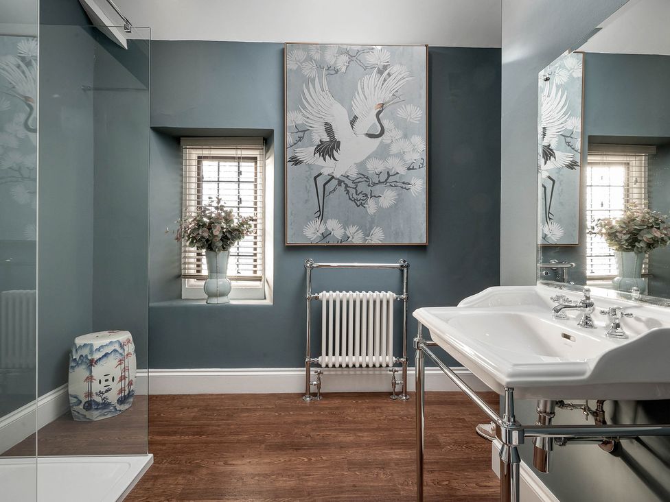 A bathroom featuring a sink, shower, and decorative elements at Greenwood Manor in Peterborough
