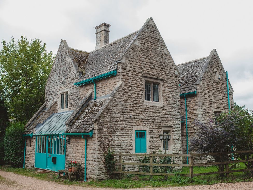 A house with a turquoise door and windows at Greenwood Manor in Peterborough