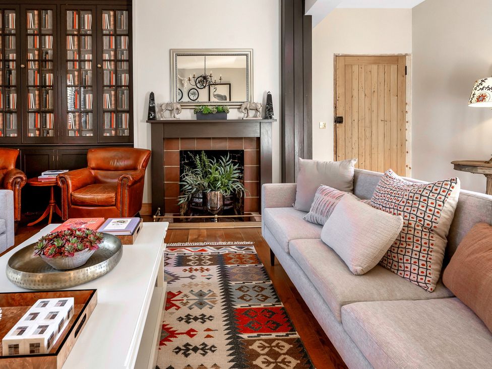 A living room with a sofa and armchairs at The Lady Rothschild Stables in Peterborough