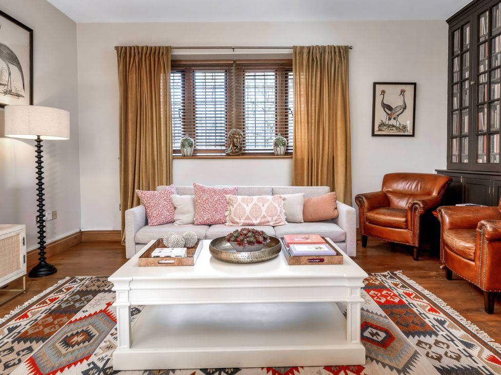A living room with a sofa and armchairs at The Lady Rothschild Stables in Peterborough