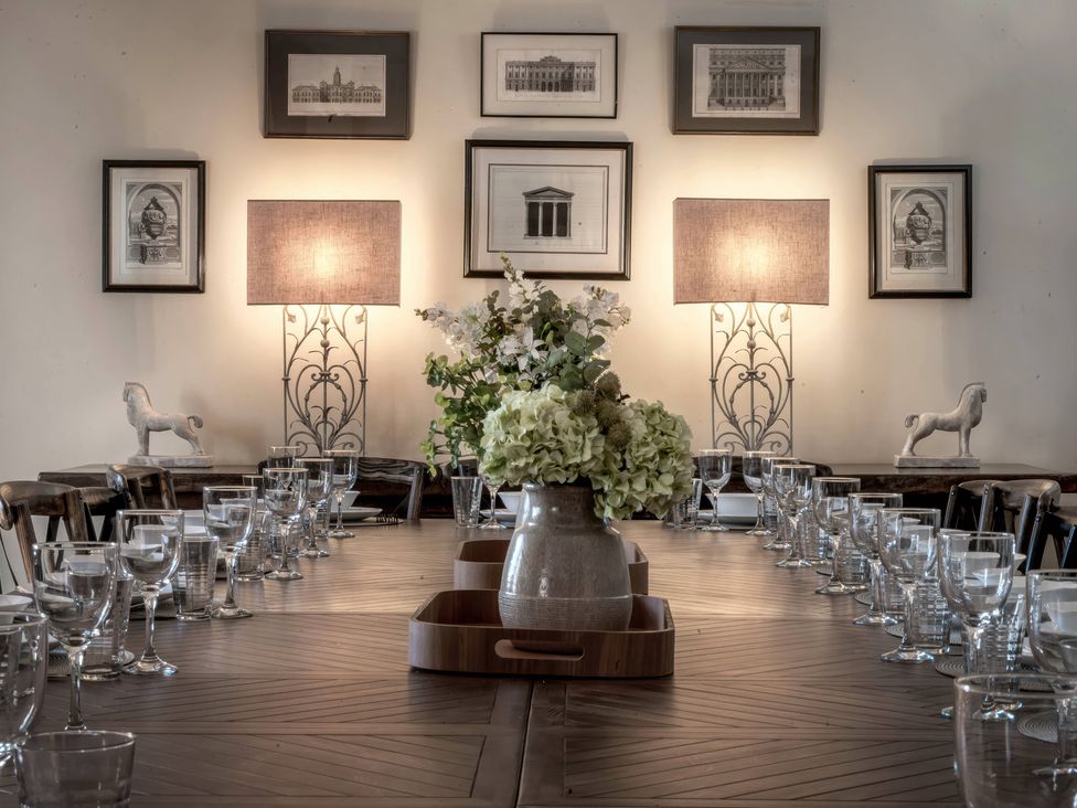 A dining room with a table set for a meal at The Lady Rothschild Stables in Peterborough