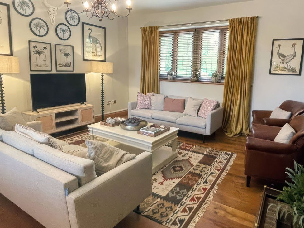 A living room with sofas and a television at The Lady Rothschild Stables in Peterborough