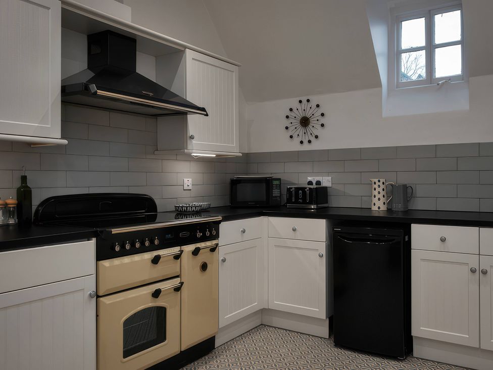 A kitchen with appliances and cabinetry at The Lady Rothschild Stables in Peterborough