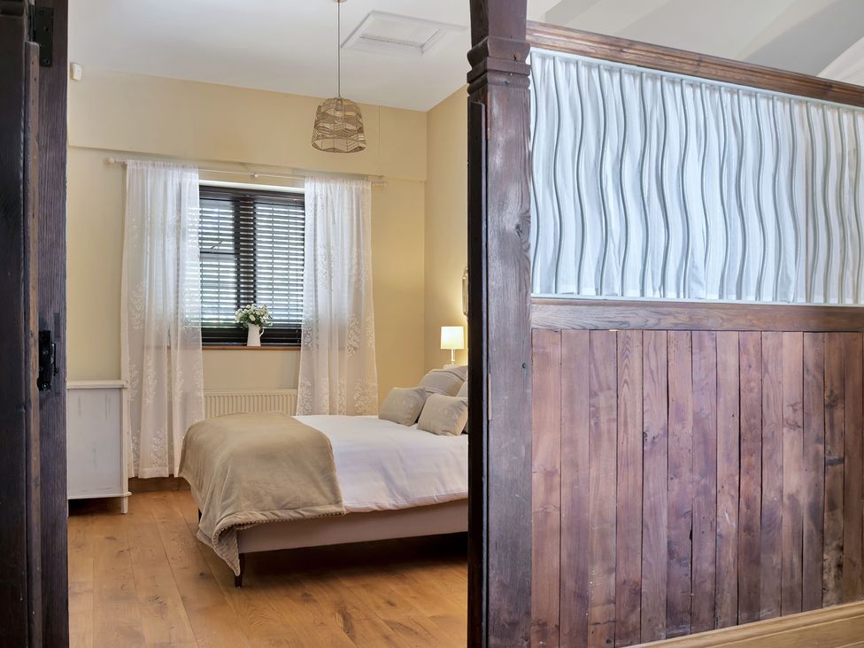 A bedroom with a bed and a window at The Lady Rothschild Stables in Peterborough