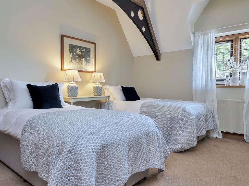 A bedroom with two beds and a window at The Lady Rothschild Stables in Peterborough